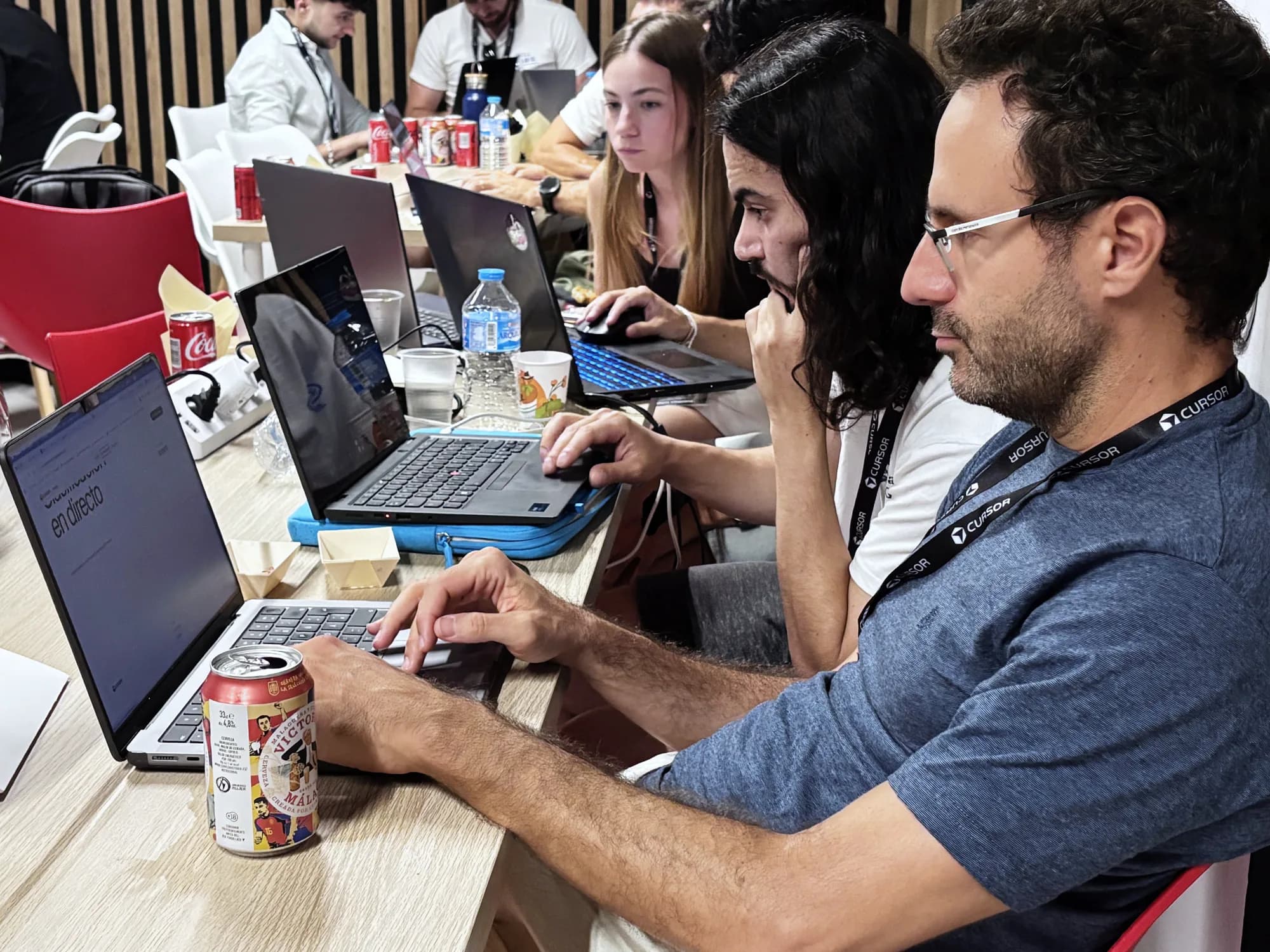 Close view of participants coding during Cursor Build Night Málaga